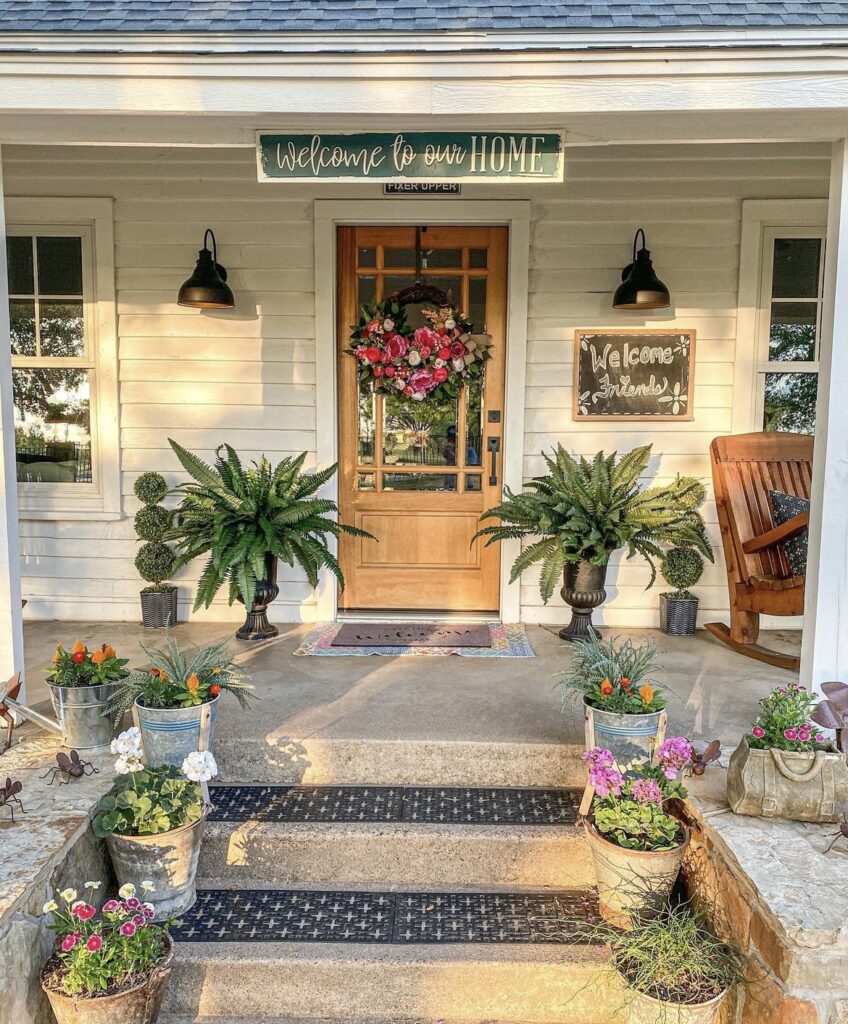 A pink rose wreath on a wooden front door.