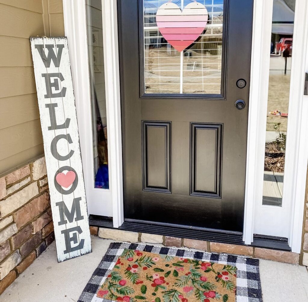 A front porch with a heart sign and welcome sign.