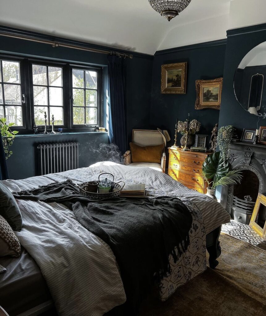 A bedroom with a black fireplace.