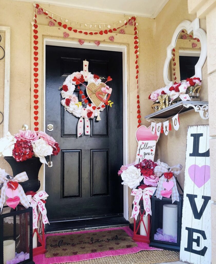 A front porch with a Valentine garland and wreath.