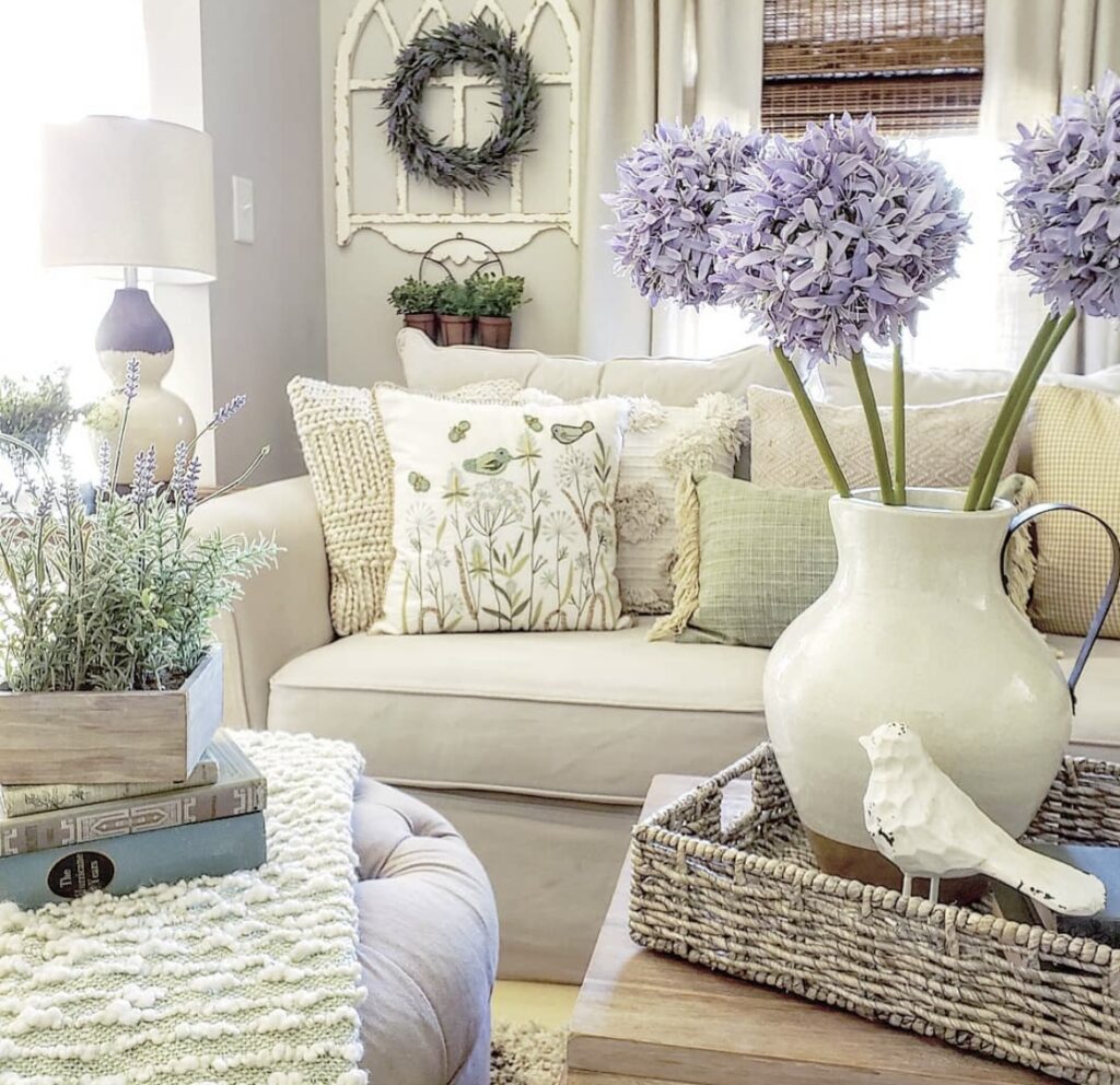 A bird figurine with purple flowers in a living room.