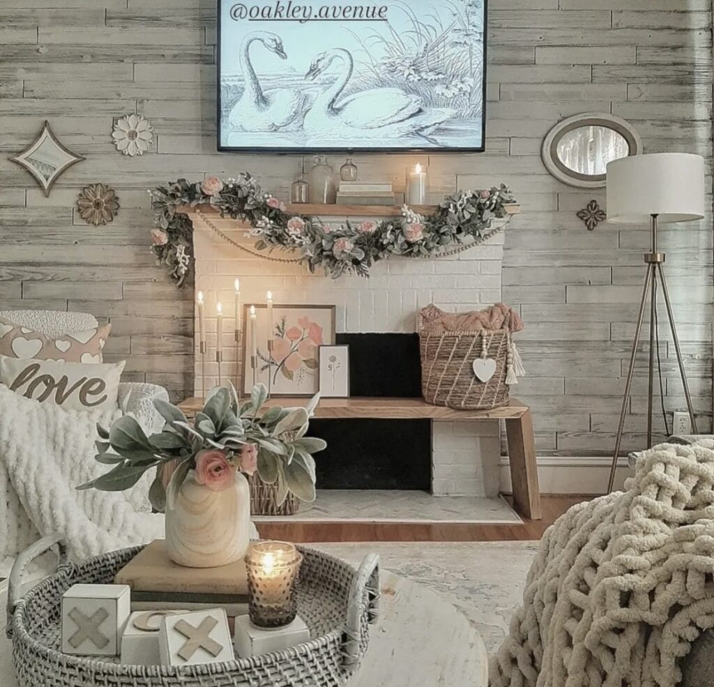 An eucalyptus and rose garland on a mantel.