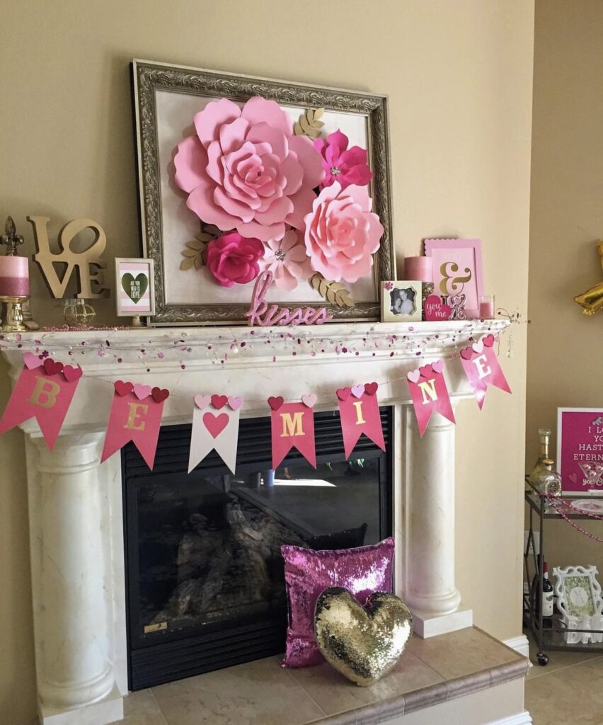 A mantel with Valentine garlands and paper flowers.