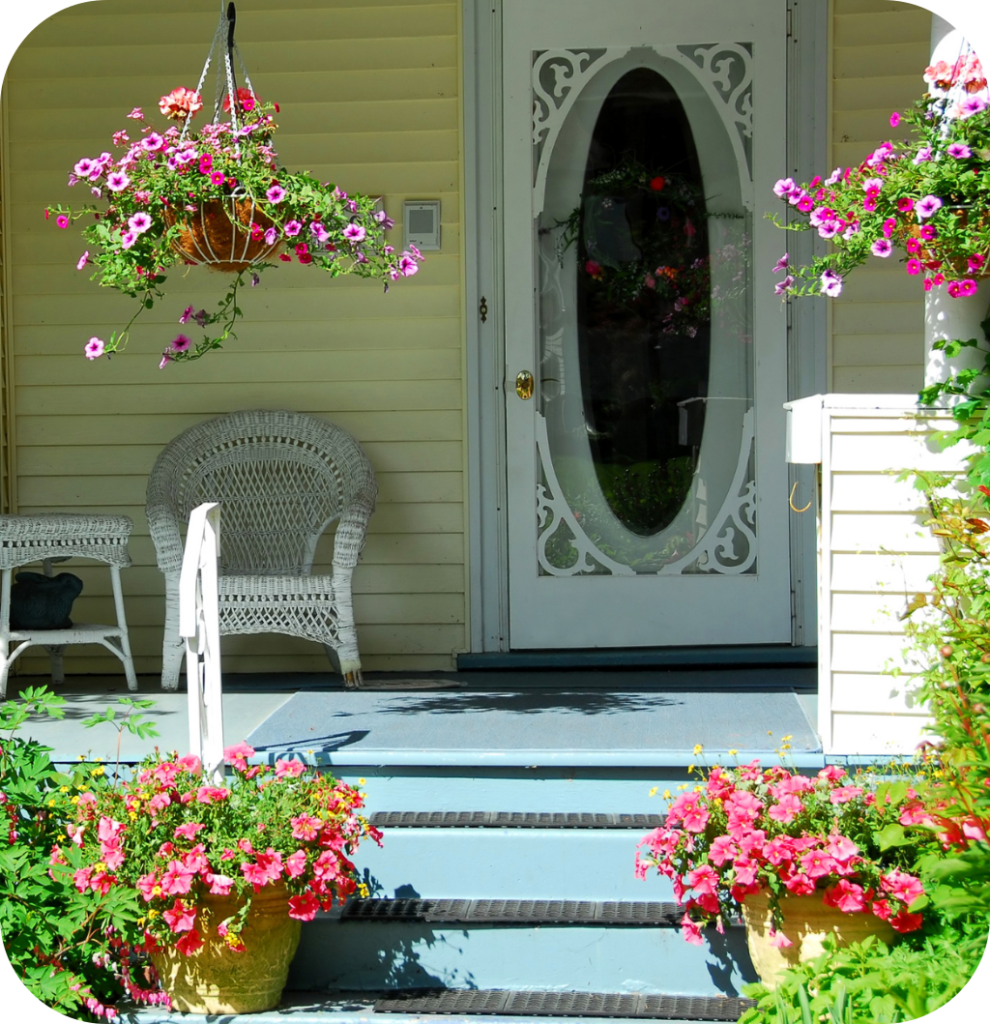 A front porch with flowers.