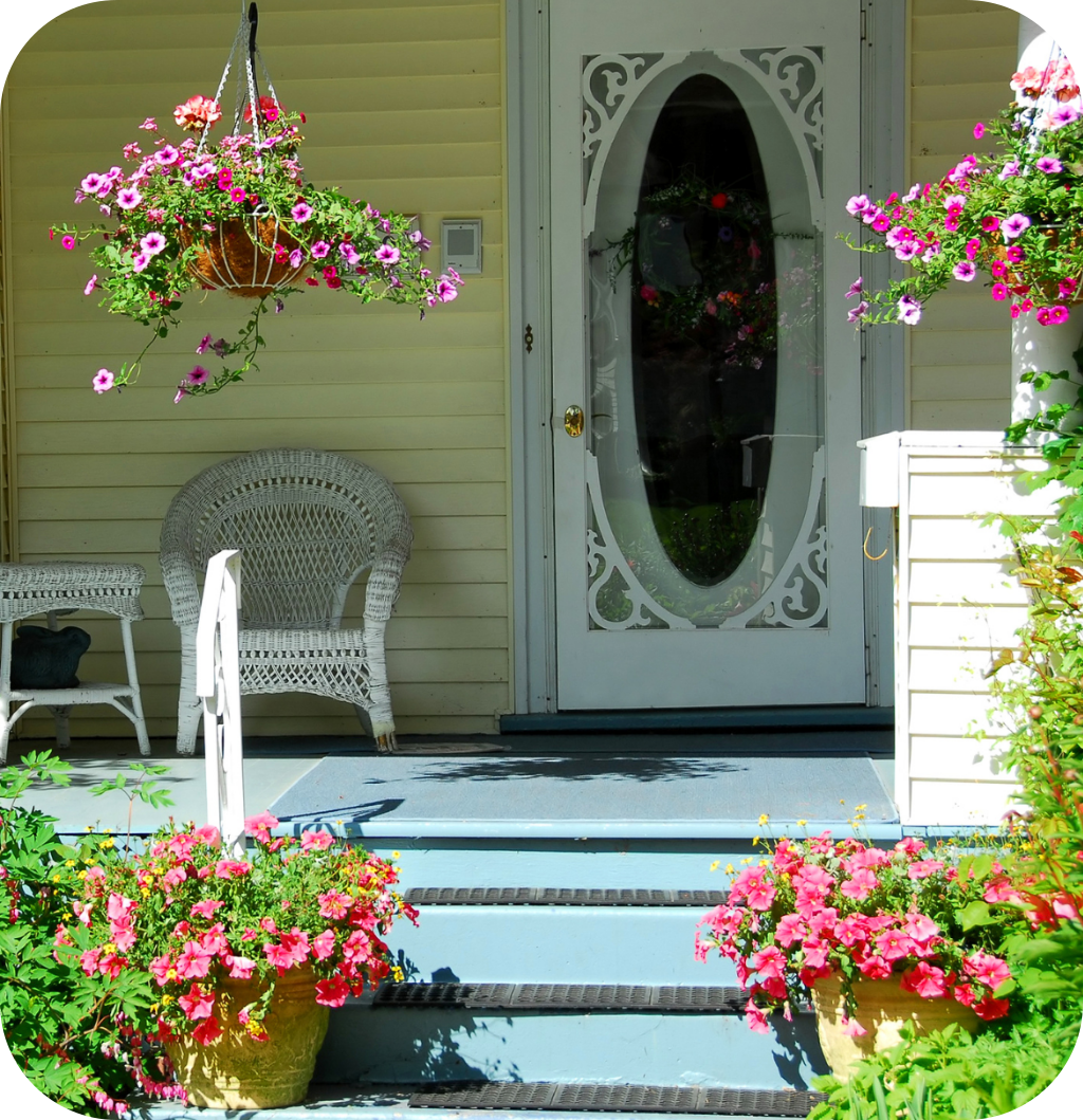 A front porch with flowers.