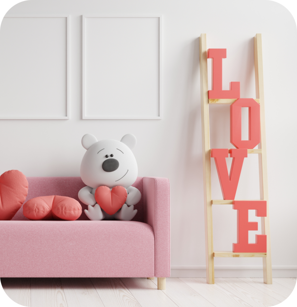 A pink sofa with heart pillows and a love sign.