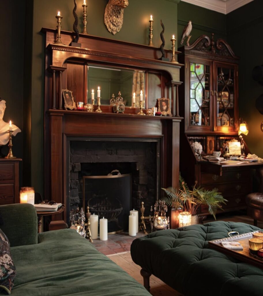 A fireplace in a dark green living room.