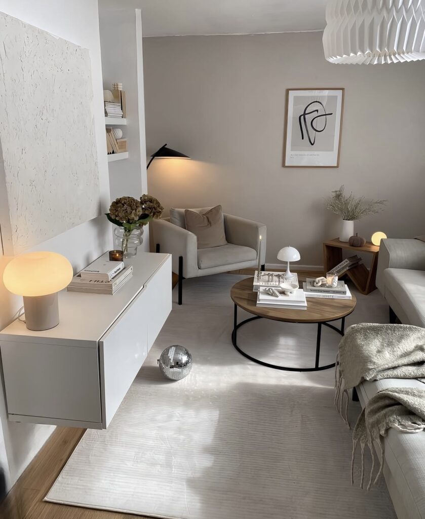 A modern living room with a round wooden coffee table.