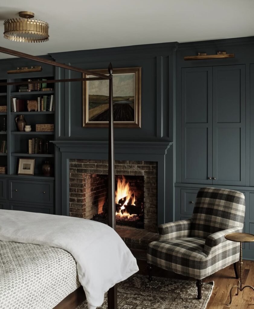 A bedroom with a fireplace.