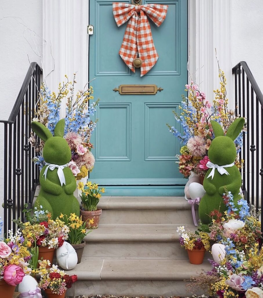 Moss rabbit figurines on front porch steps.