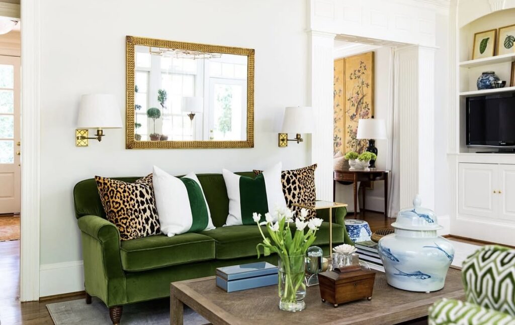 A traditional living room with animal patterned pillows.