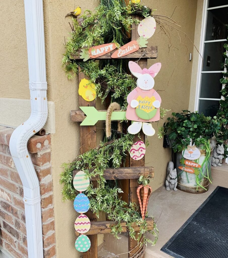 A wooden ladder filled with greenery and Easter cutouts.