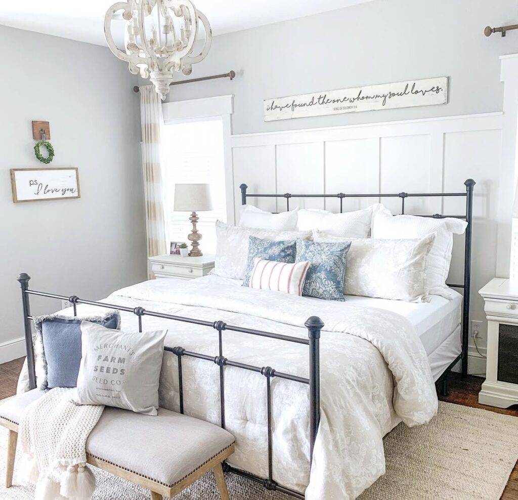 A modern bedroom with a black metal bed and wooden nightstands.