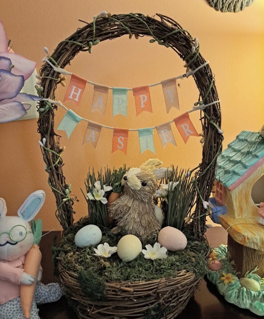 An Easter basket with moss and a rabbit figurine.