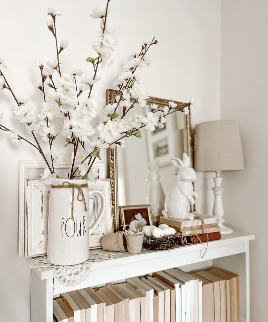 White cherry blossom branches with a rabbit figurine.