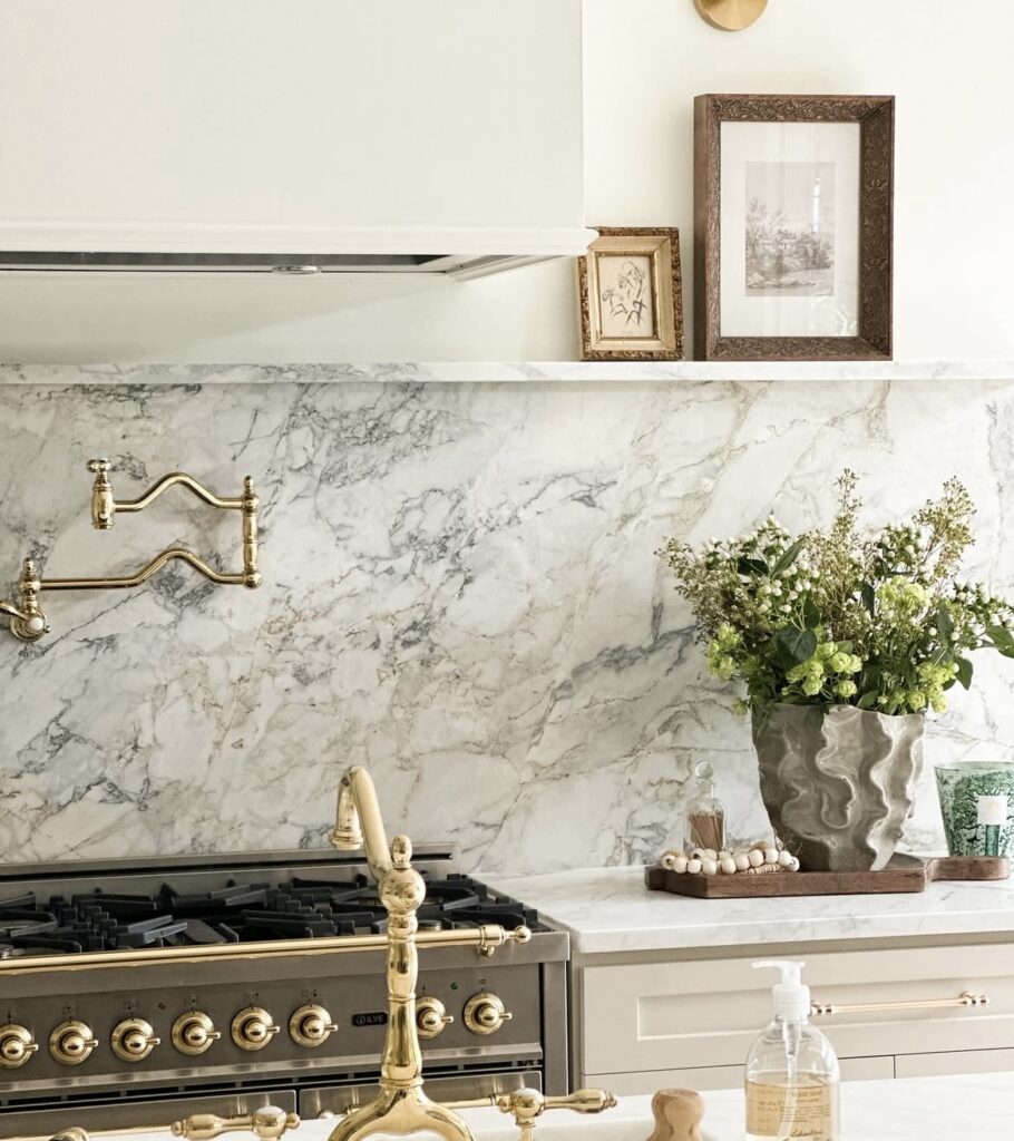 A modern kitchen with a marble backsplash.