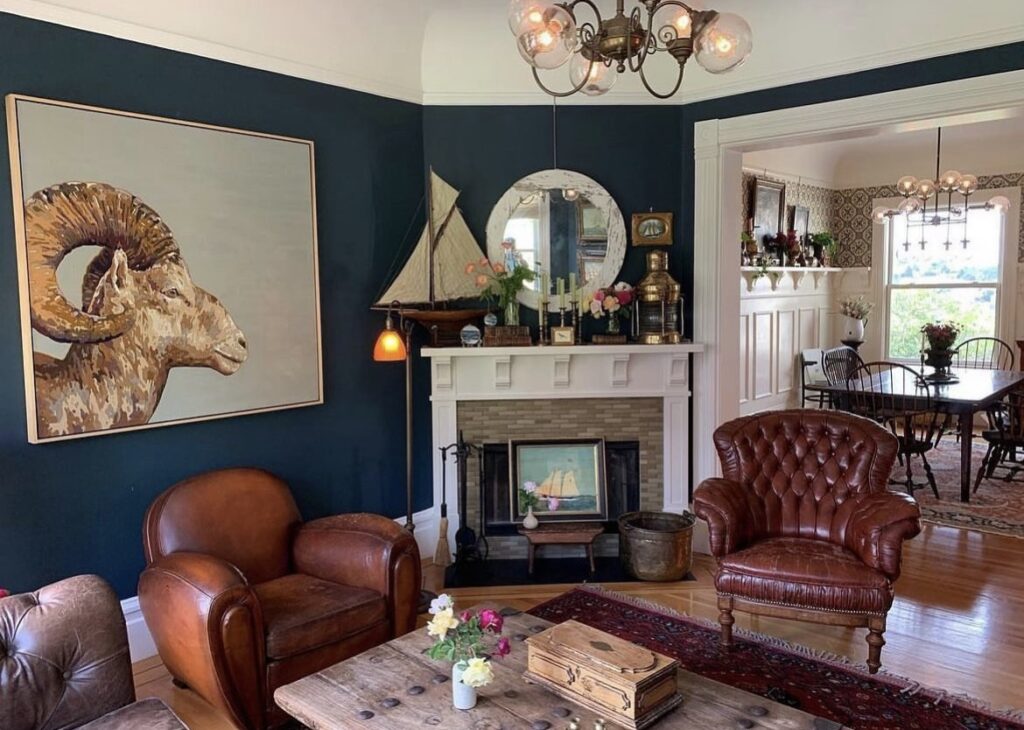 A classic living room with an aries painting.