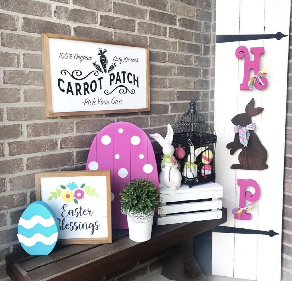 A hop sign, an Easter blessings sign, a carrot patch sign and Easter egg cutouts on a front porch.