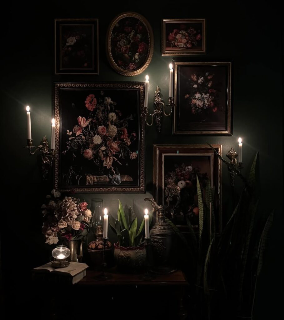 A black living room with oil paintings and candles.