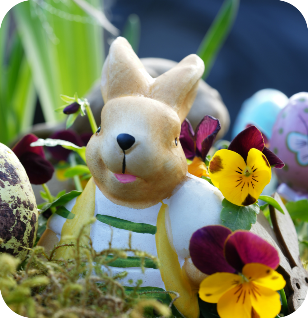 A rabbit figurine with flowers.