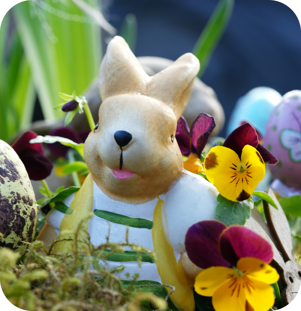 A rabbit figurine with flowers.