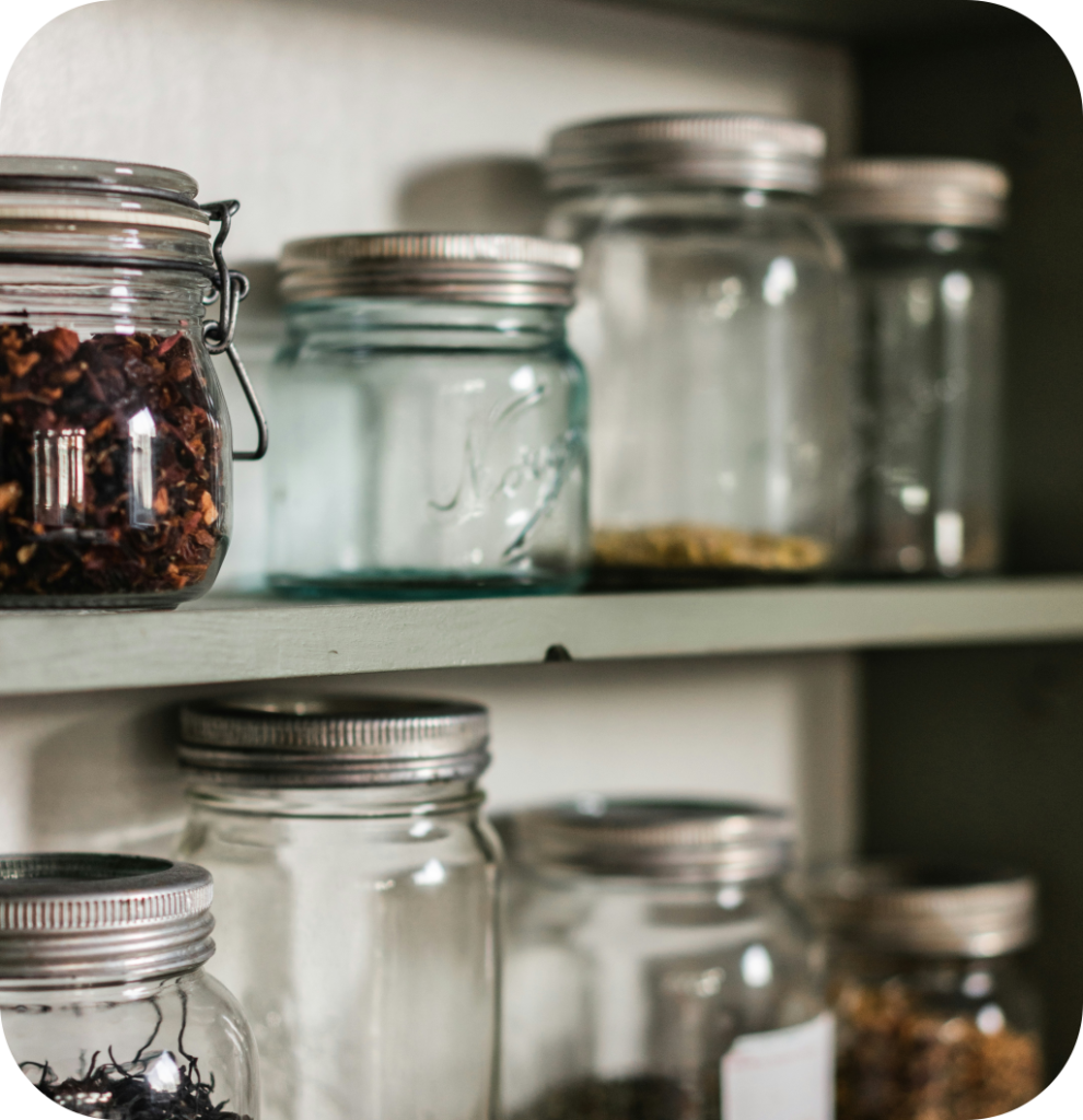 Glass jars in a small pantry.