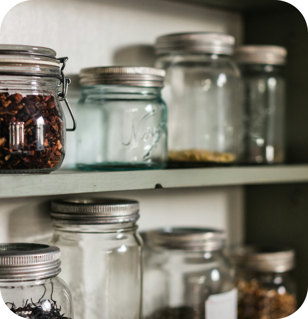 Glass jars in a small pantry.