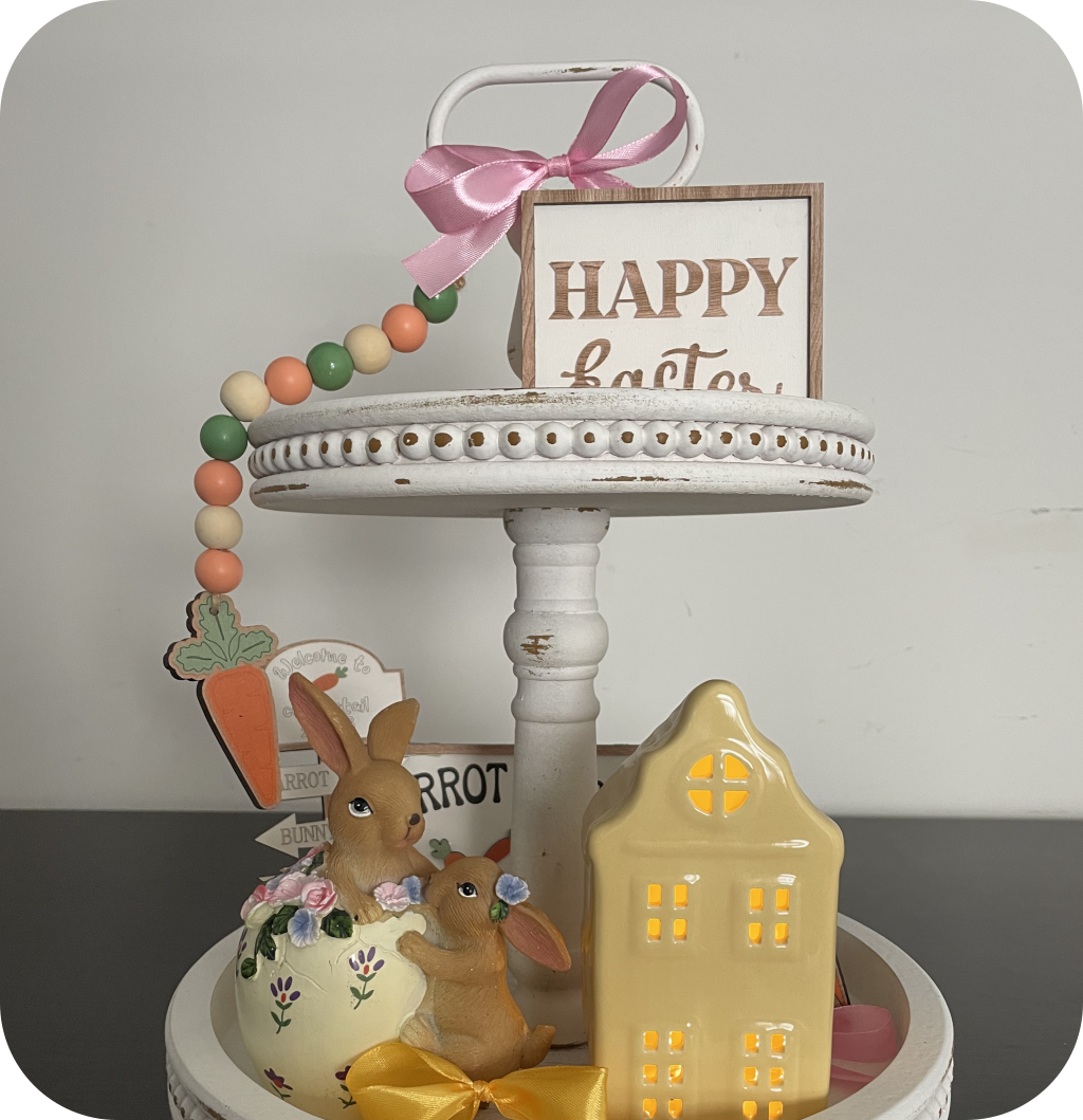 A 2 tiered tray with bunny figurines, Easter signs, ribbon bows, and Easter eggs. ©ASTRAPEARL - DO NOT USE