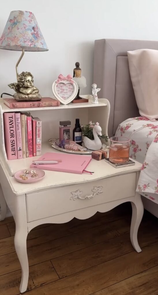 A white nightstand with angel statues.