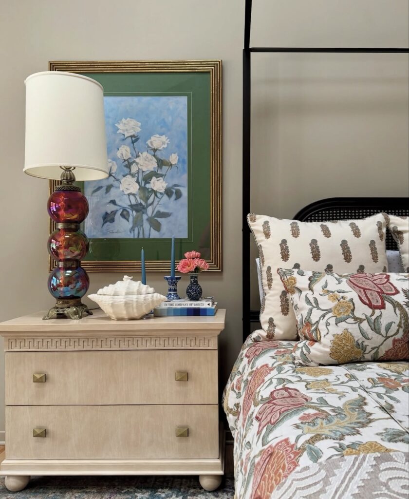 A wooden nightstand with patterned vases and a unique lamp.