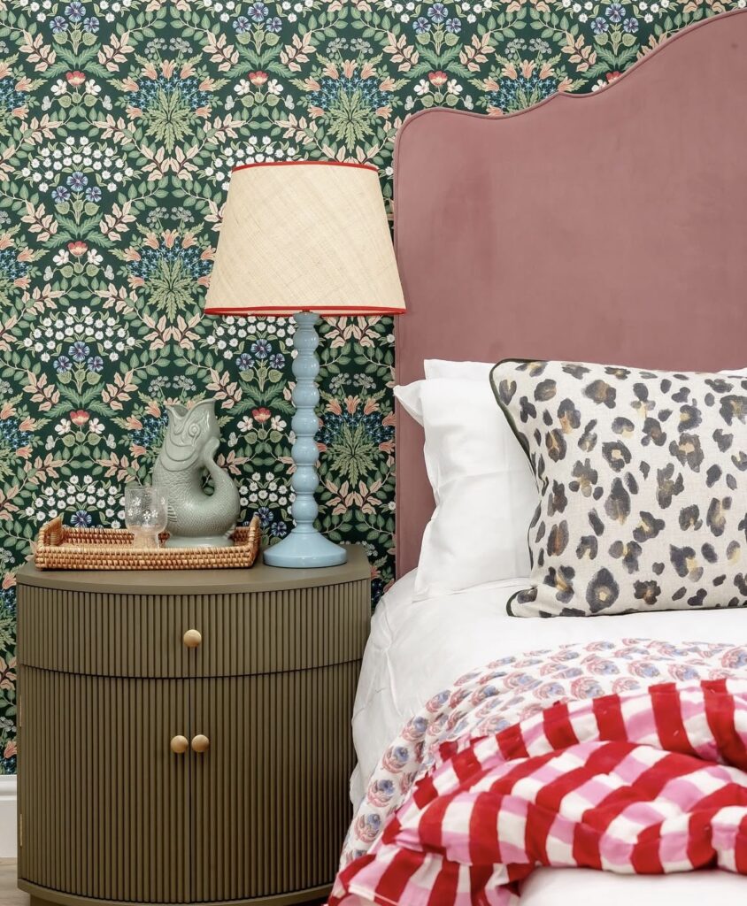 A brown retro nightstand with a blue lamp and a fish figurine.