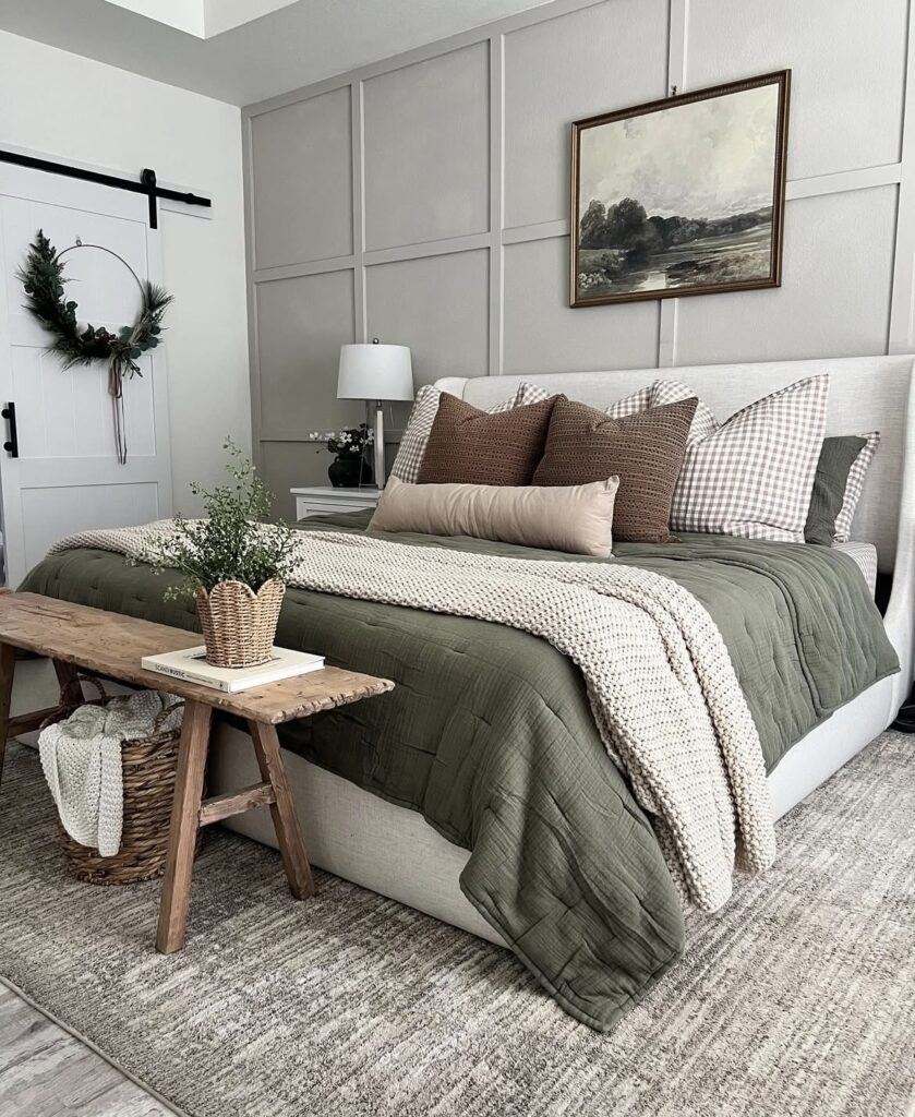 An earthy bedroom with a landscape painting.