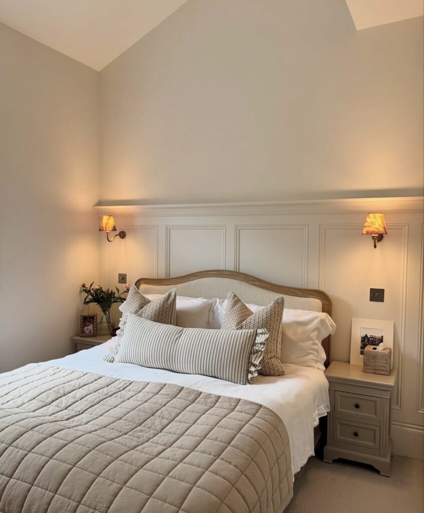 A minimalist bedroom with a wooden headboard.
