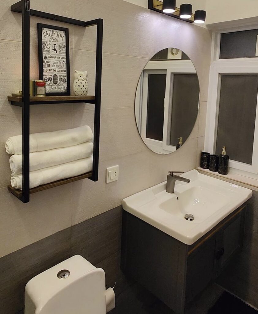 A modern bathroom with a black towel rack.