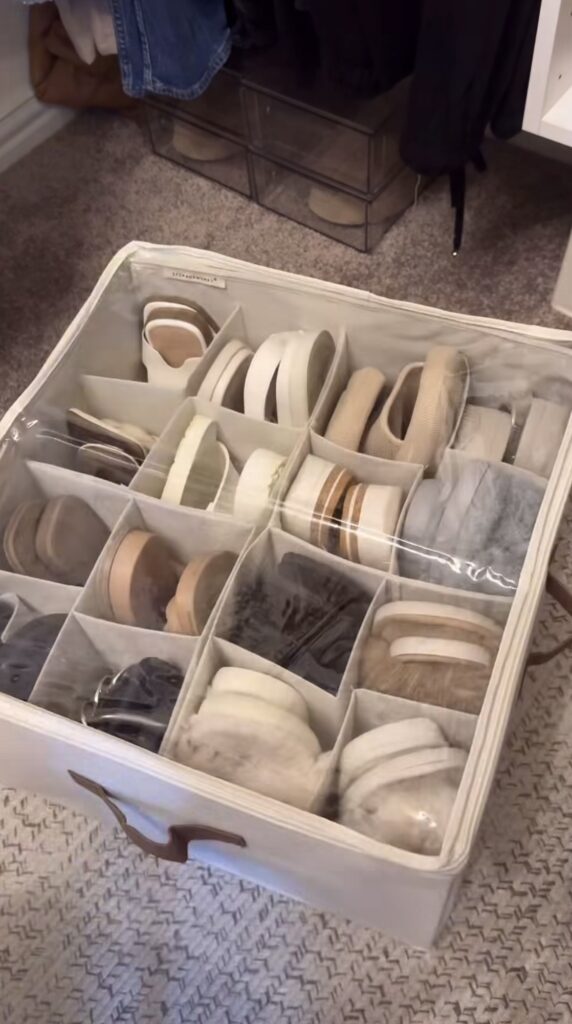 A beige shoe storage box in a closet.