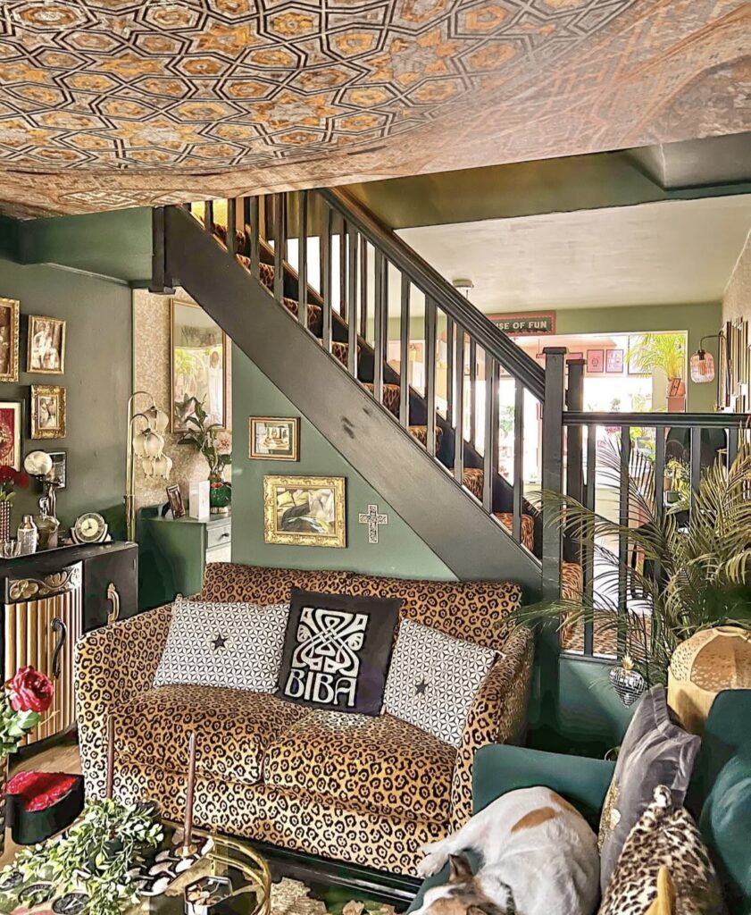 A patterned ceiling in a green living room.
