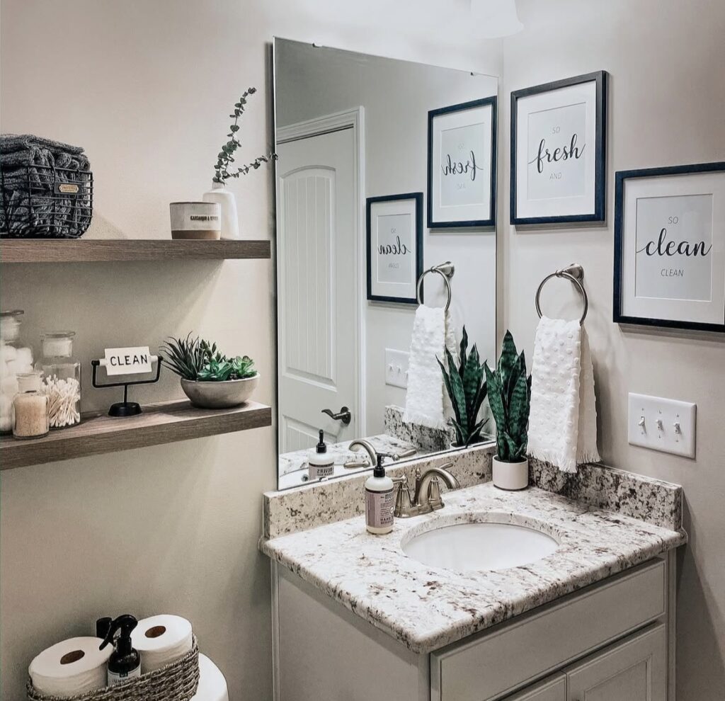 A bathroom with clear jars on wall mounted shelves.