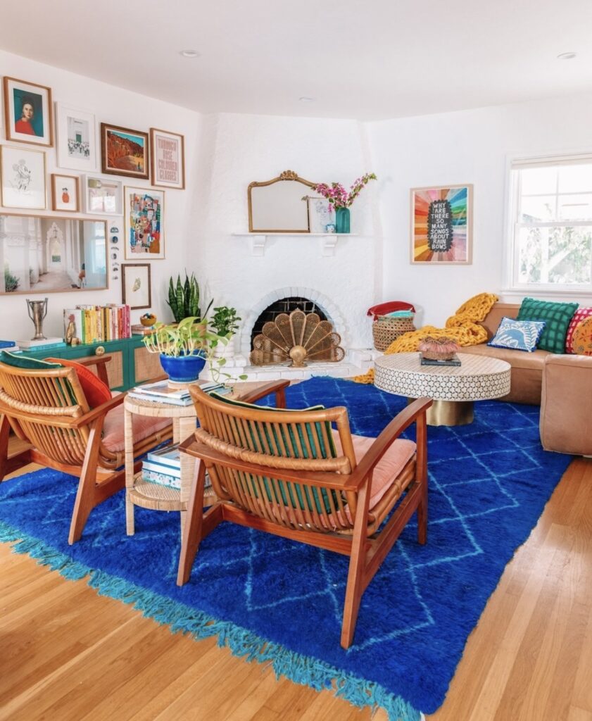 A living room with a large blue rug.