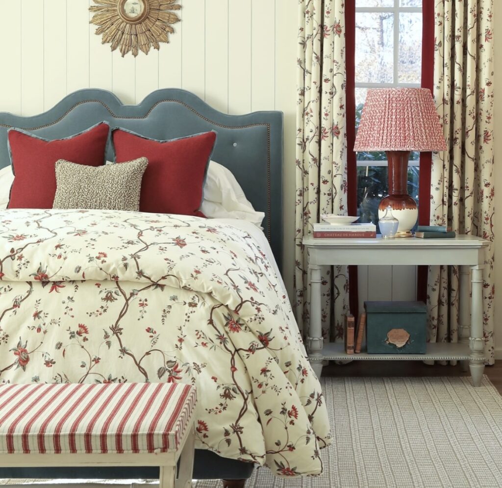 A traditional red and blue bedroom with vintage patterns.