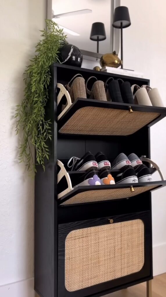 An entryway with a shoe cabinet with flip drawers.