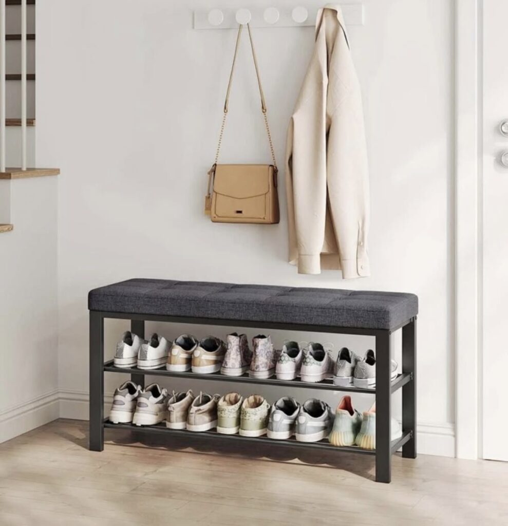An entryway with a black shoe rack and bench.