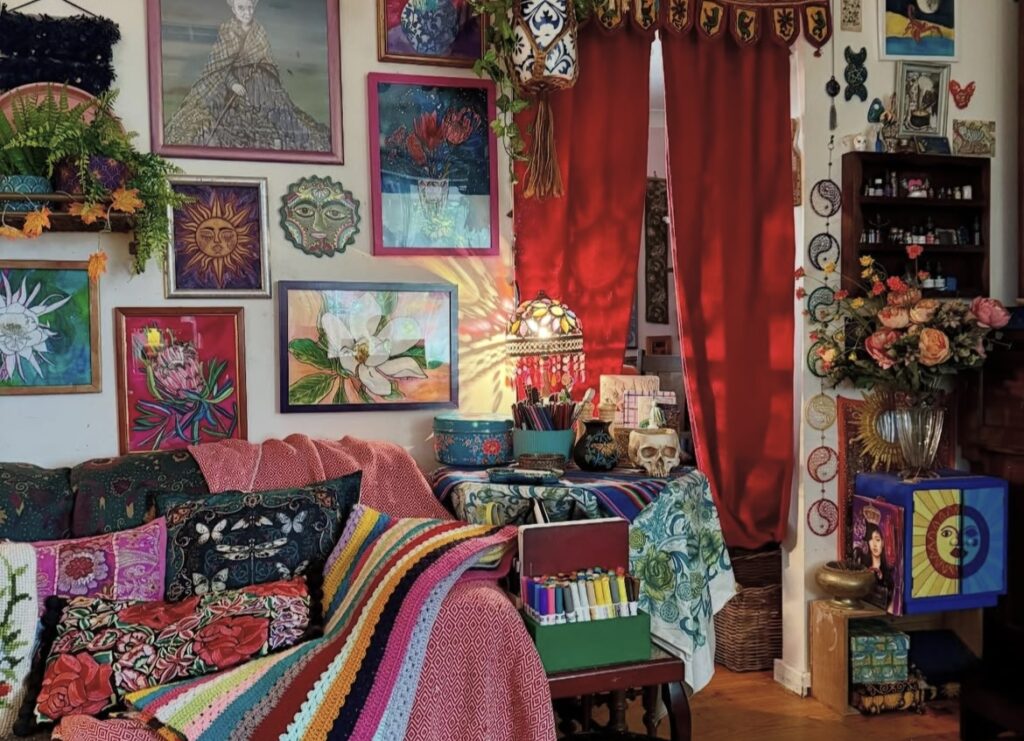 A living room with a gallery wall and red curtains.