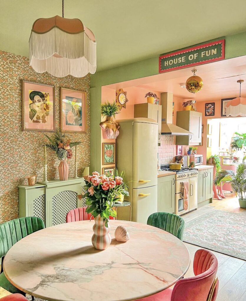 A retro dining room and kitchen with pink and green shades.