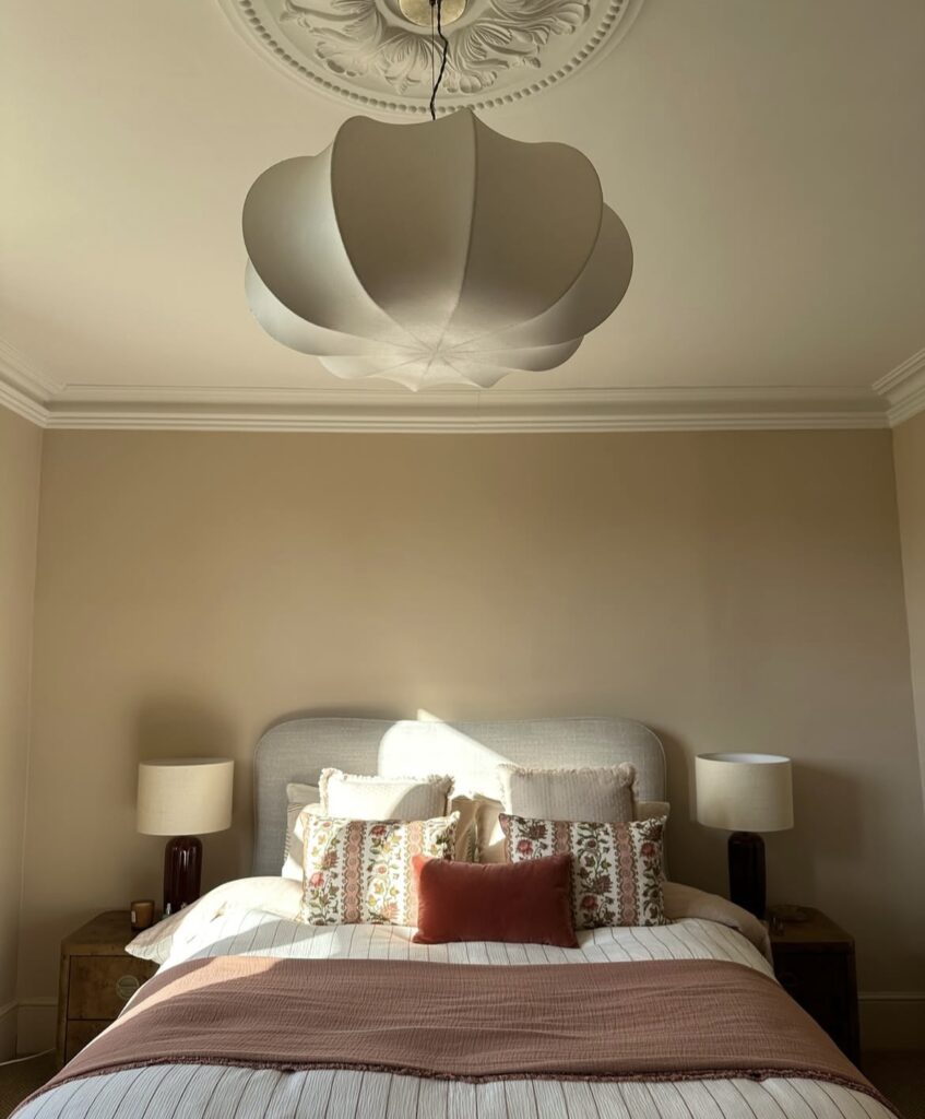 A bedroom with vintage patterned pillows.