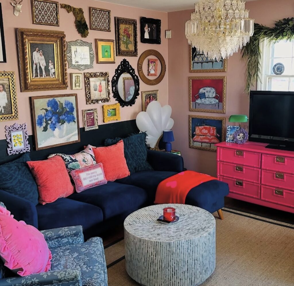 A pink living room with a gallery wall.
