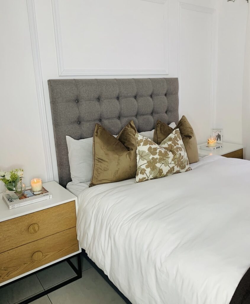 A bedroom with gold pillows.