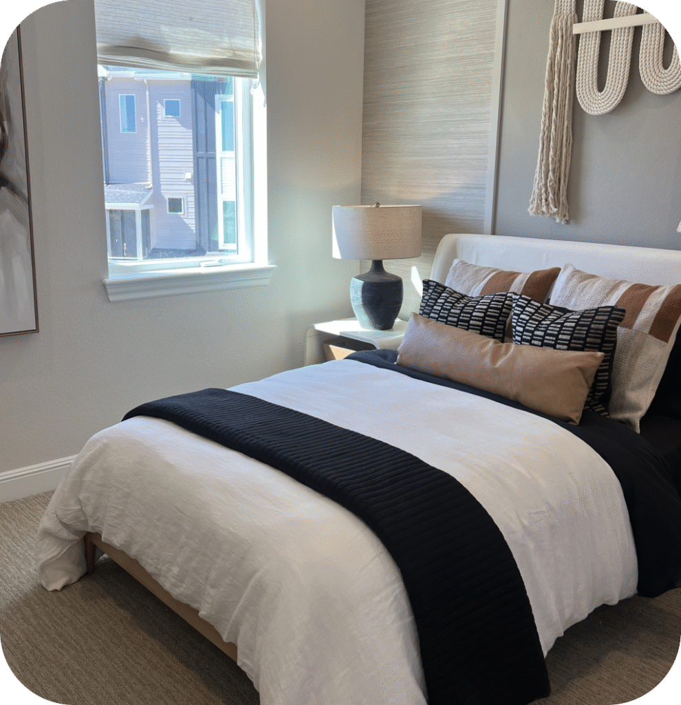 A modern bedroom with black, white and brown shades.