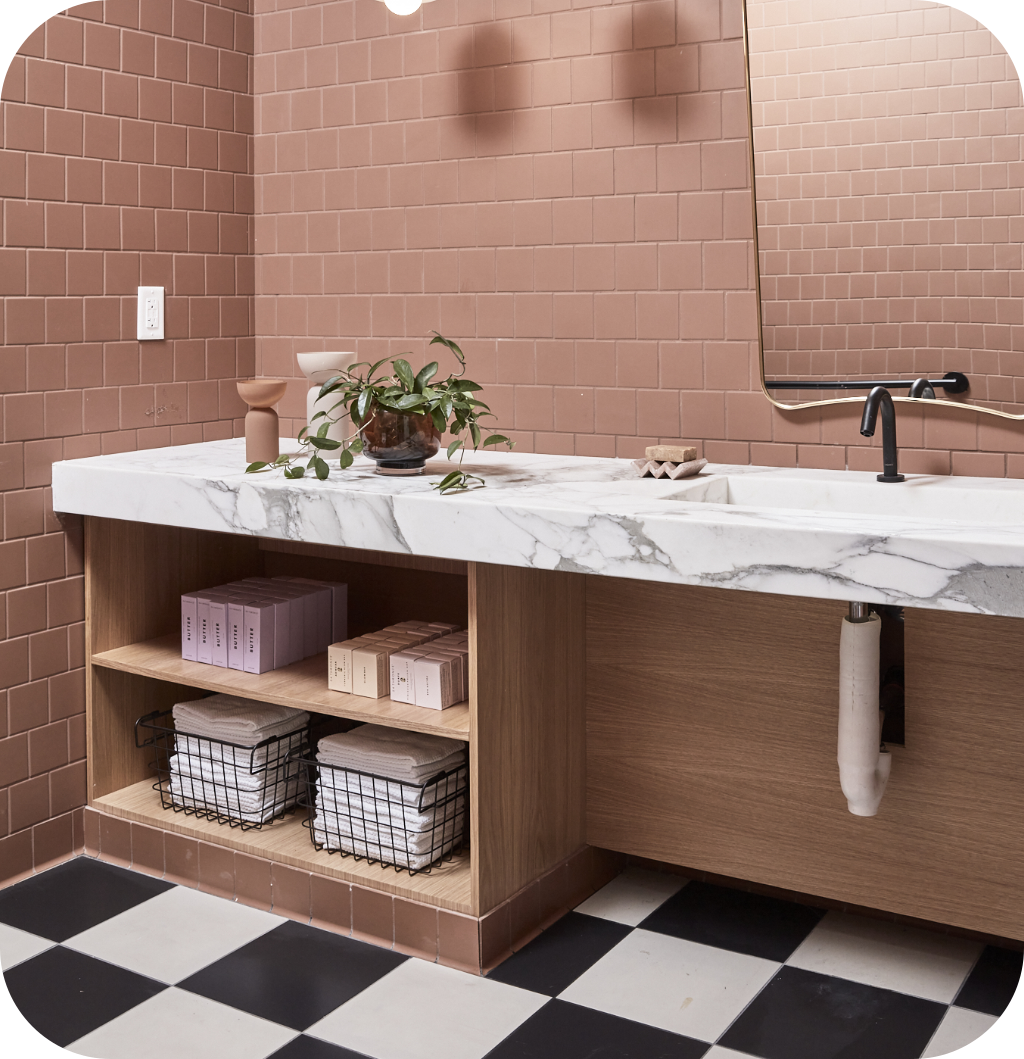 A pink bathroom with organizers.