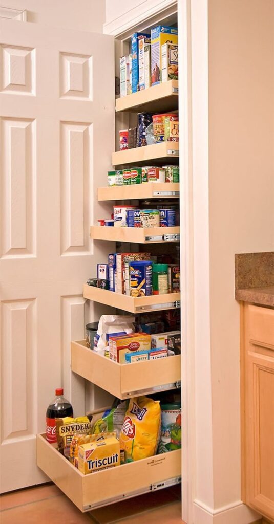 A kitchen cabinet with pull-out drawers.