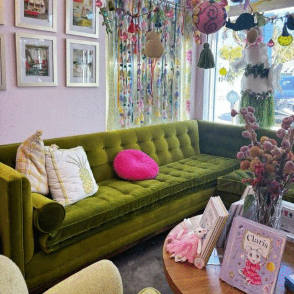 An eclectic living room with an antique green sofa.